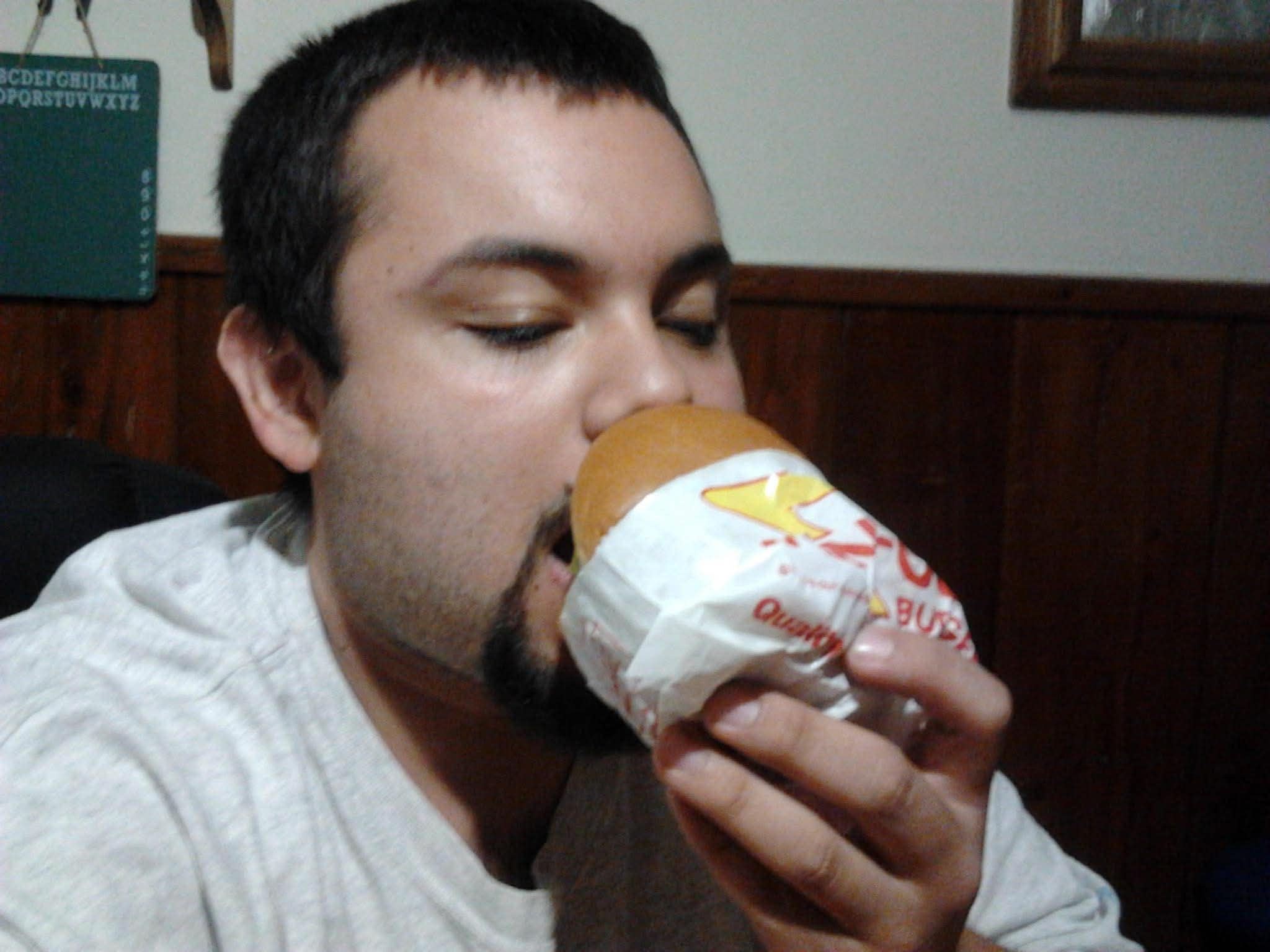 Young Michael partaking of a wrapped Whataburger meal.